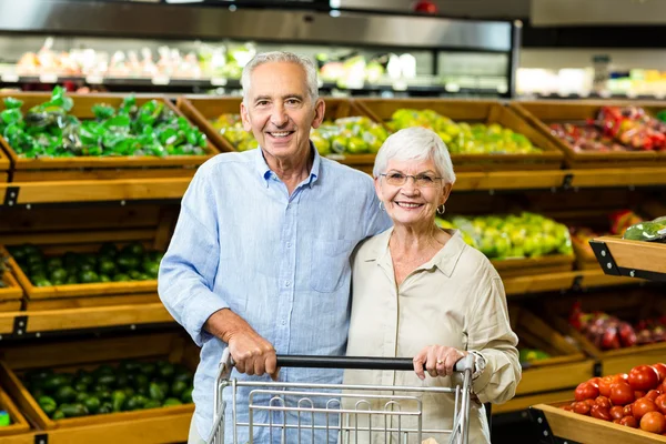 Happy senior couple with cart — Stock Photo, Image