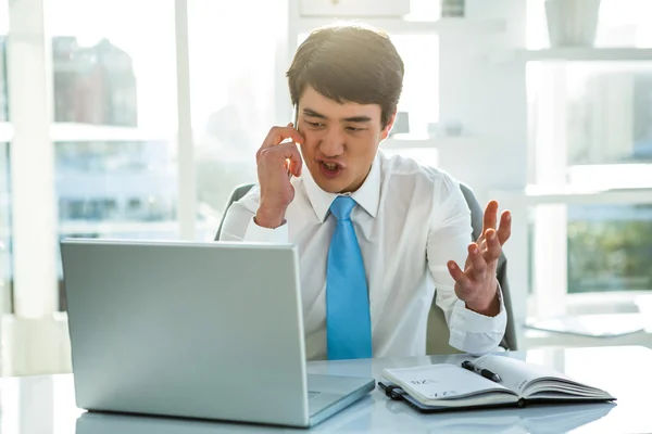 Busy asian businessman working on laptop — Stock Photo, Image