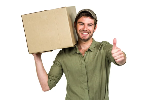 Handsome postman holding pack showing thumbs up — Stock Photo, Image