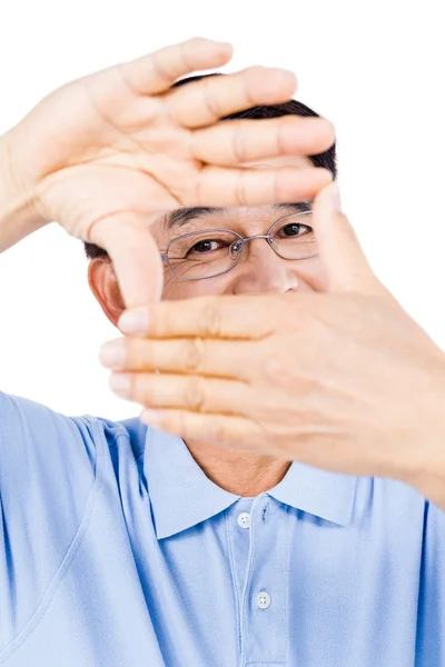 Portrait of man looking through hands — Stock Photo, Image