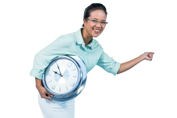 Delighted businesswoman holding a clock — Stock Photo, Image