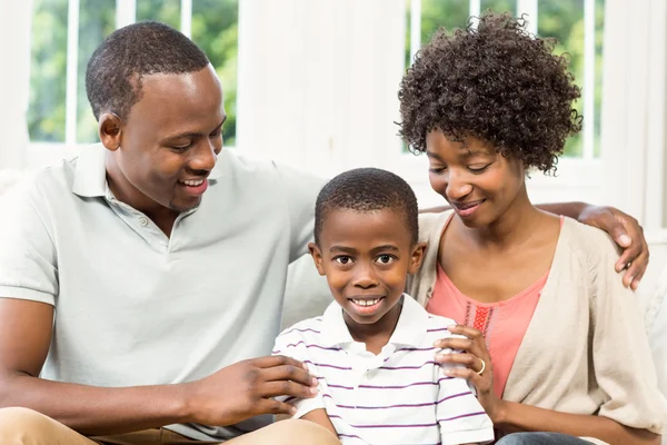 Happy family sitting on the couch — Stock Photo, Image