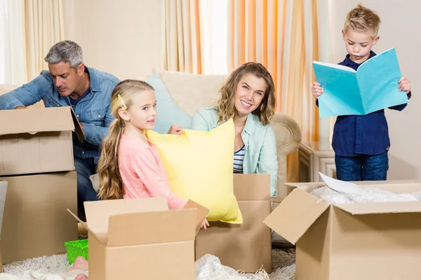 Cute family opening boxes — Stock Photo, Image