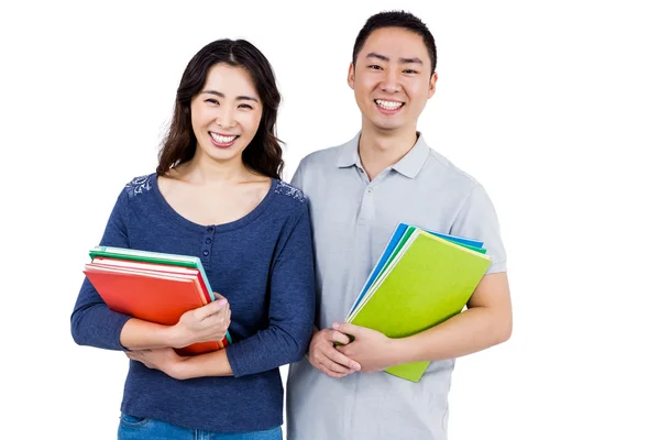 Pareja feliz sosteniendo libros — Foto de Stock