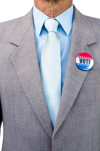 Businessman posing with badge — Stock Photo, Image