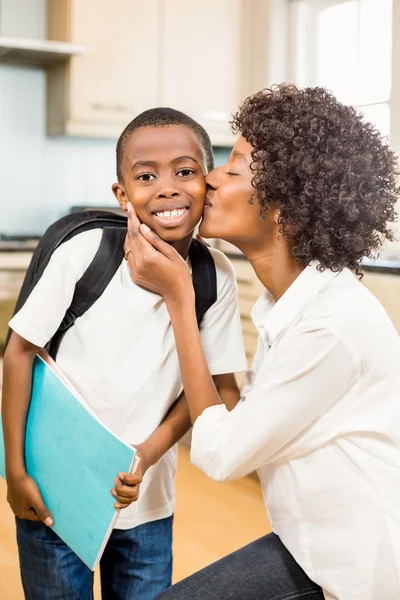 Mother kissing son in the kitchen — Stock Photo, Image