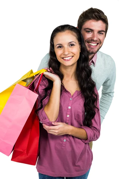 Pareja sonriente sosteniendo coloridas bolsas de compras —  Fotos de Stock