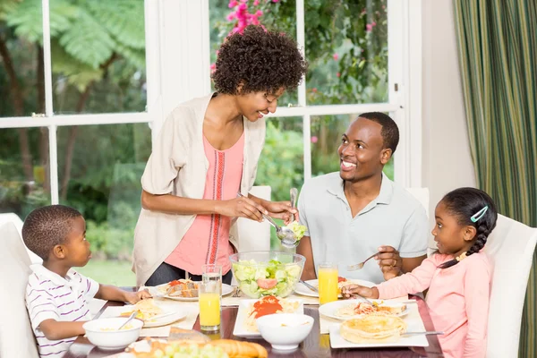 Happy family enjoying their meal — Stock Photo, Image