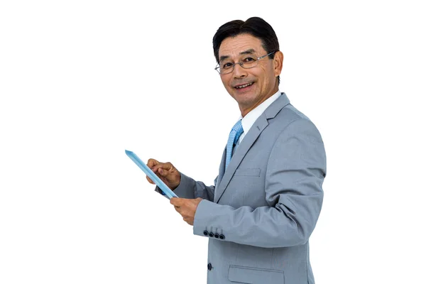 Smiling businessman using his tablet — Stock Photo, Image