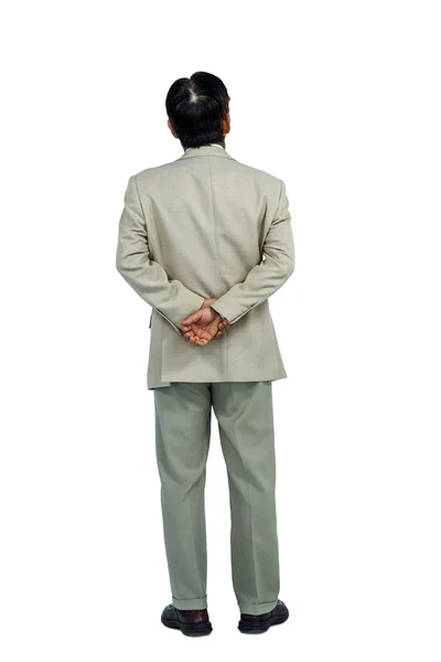 Uomo d'affari guardando con le mani dietro la schiena — Foto Stock
