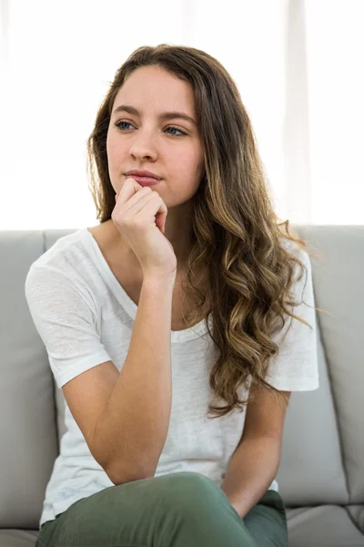 Mujer pensando con la mano en la barbilla — Foto de Stock