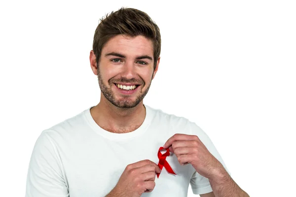 Portrait of smiling man with red ribbon — Stock Photo, Image