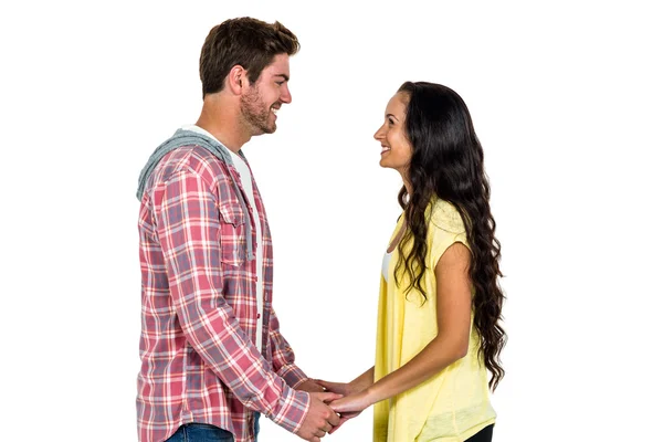 Smiling couple holding hands and looking at each other — Stock Photo, Image