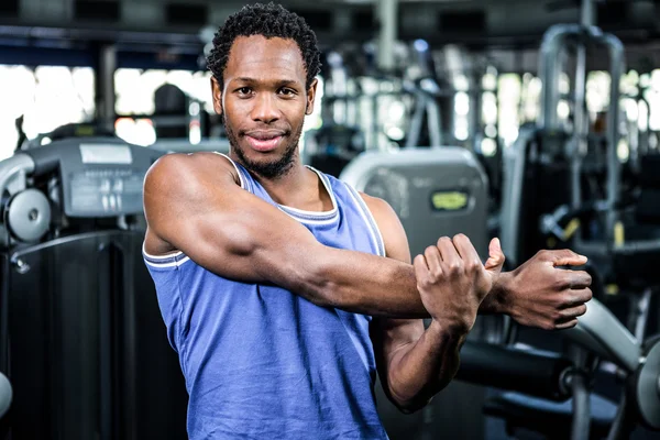 Uomo muscoloso stretching braccia — Foto Stock