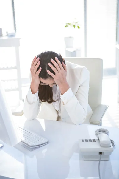 Mujer de negocios estresada trabajando en su escritorio — Foto de Stock
