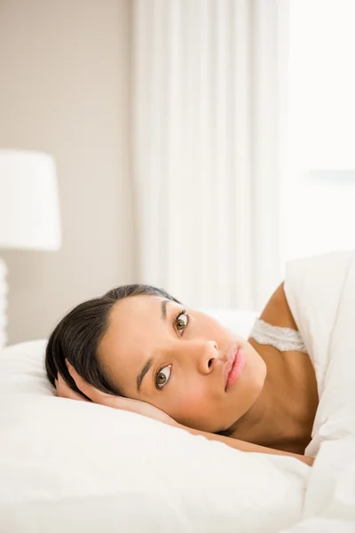 Attractive brunette on bed Stock Picture