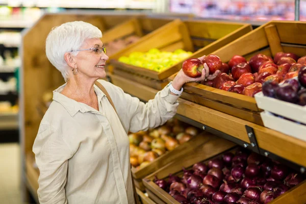 Idősebb nő, szedés ki a piros Alma — Stock Fotó