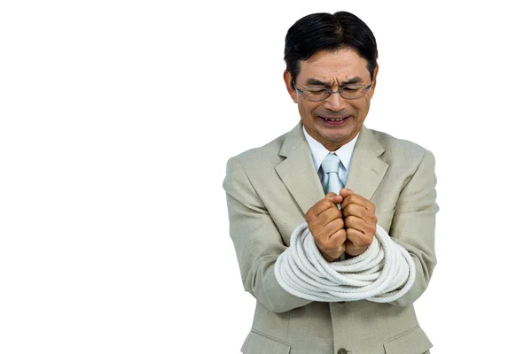 Asian businessman tied up in rope — Stock Photo, Image