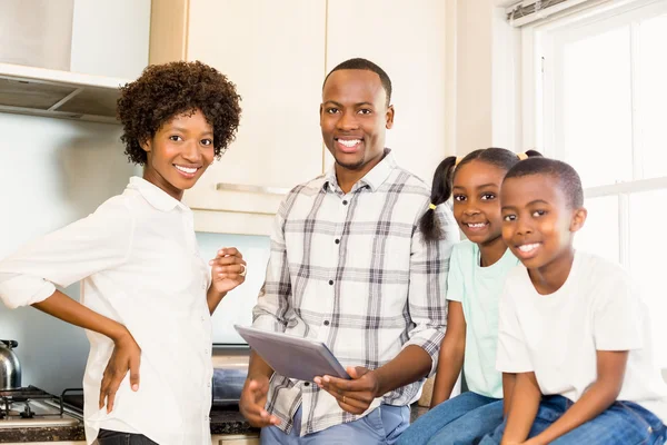 Happy family looking at tablet — Stock Photo, Image