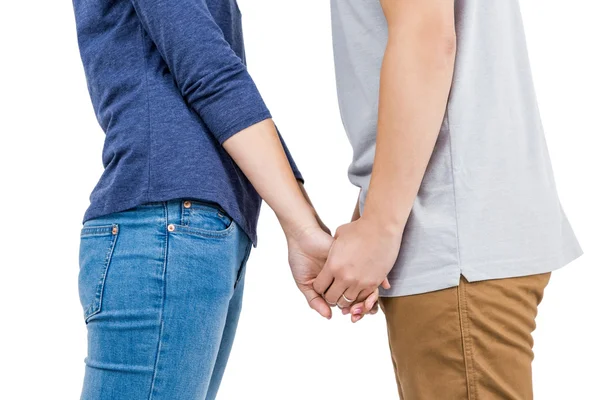 Mid section of couple holding hands — Stock Photo, Image