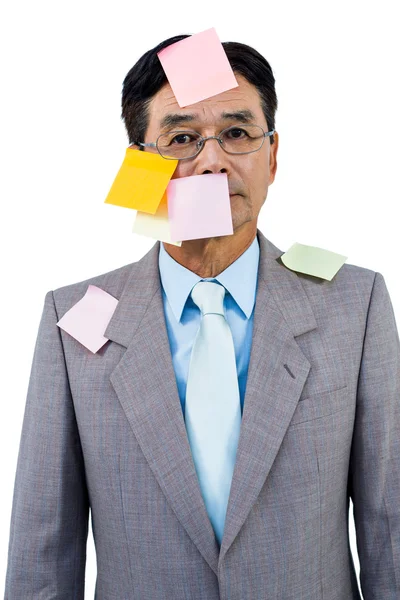 Businessman with blank note over his face — Stock Photo, Image