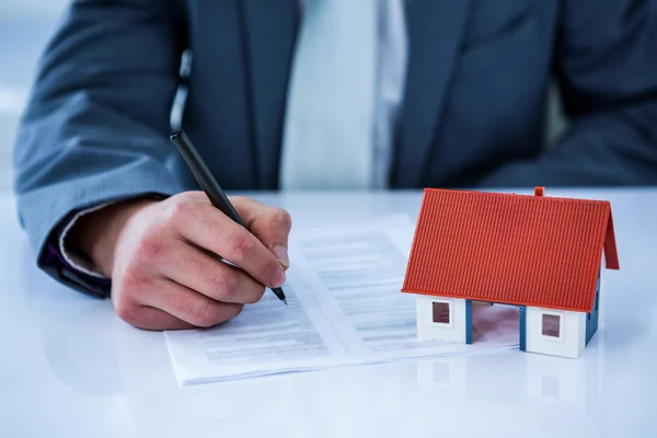 Businessman signing contract for new house — Stock Photo, Image