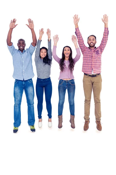 Multi-ethnic friends jumping with arms raised — Stock Photo, Image