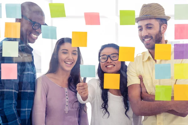 Creative people discussing over adhesive notes — Stock Photo, Image