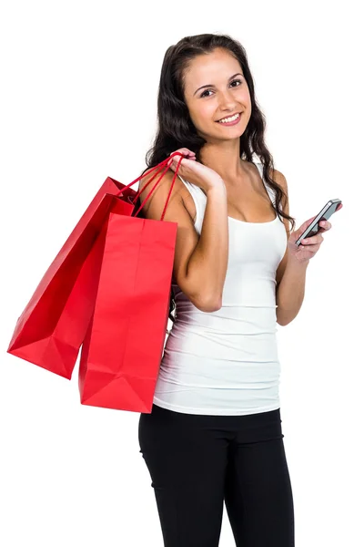 Mujer sonriente sosteniendo bolsas de compras —  Fotos de Stock