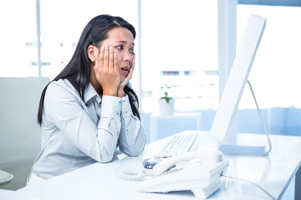 Exhausted businesswoman with hands on face — Stock Photo, Image