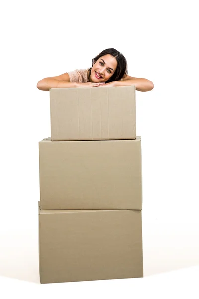 Woman standing behind cardboard box — Stock Photo, Image