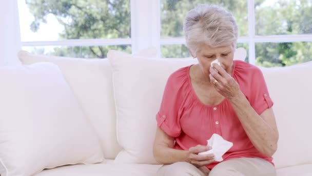 Старшая женщина плачет на диване — стоковое видео