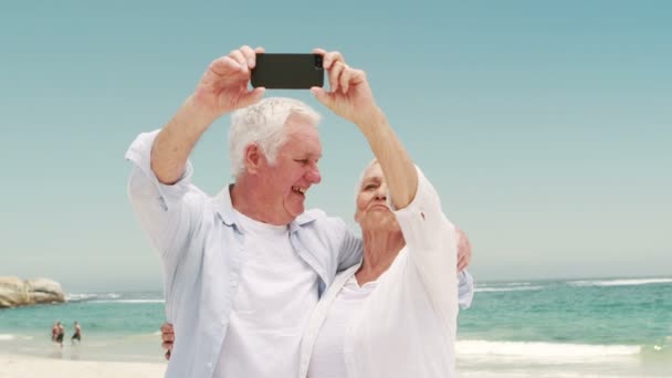 Old retired couple taking selfie together — Stock video