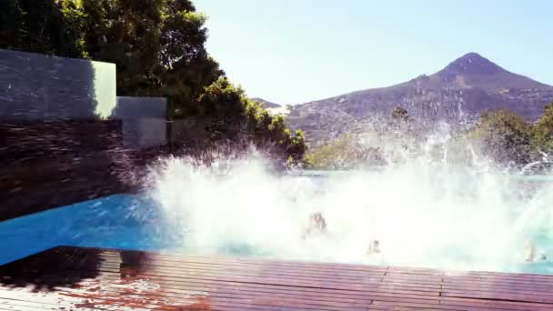 Happy friends diving into the pool — Stock Video