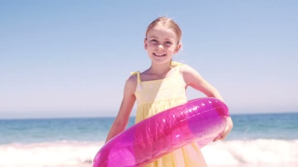 Little girl playing with her buoy on the beach — Stock Video