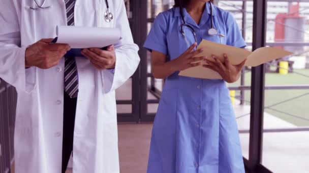 Equipo médico leyendo la relación en el portapapeles — Vídeos de Stock