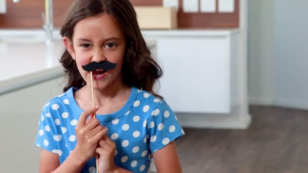 Child with fake mustache making faces — Stock Video