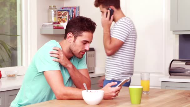 Friends using smartphones in the kitchen — Stock Video