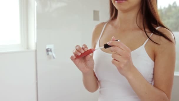 Belle femme appliquant gloss lèvre — Video