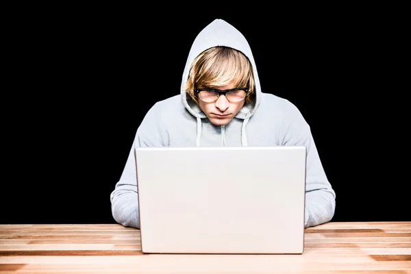 Man in hood jacket hacking laptop — Stock Photo, Image