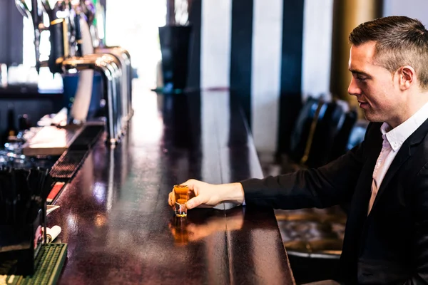 Man having an alcohol shot — Stock Photo, Image