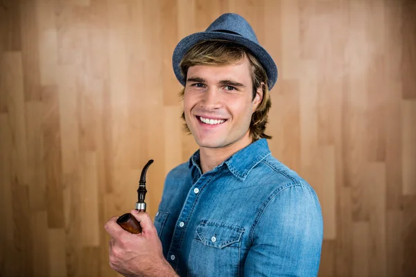 Cheerful hipster holding pipe — Stock Photo, Image