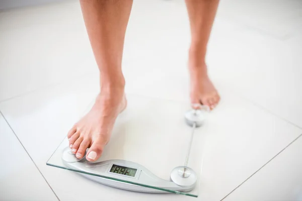 Womans feet going on weighting scale — Stock Photo, Image