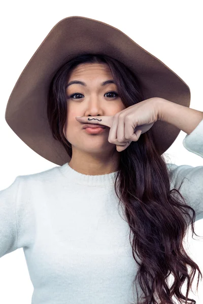Asian woman with mustache on finger — Stock Photo, Image