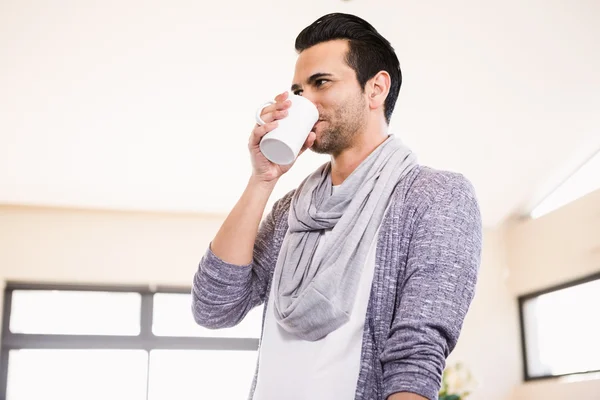 Handsome man drinking hot beverage — Stock Photo, Image