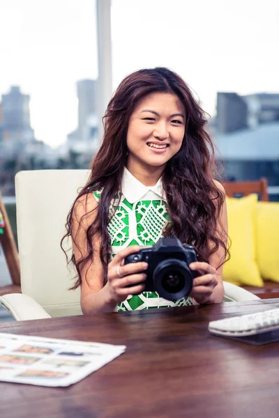 Creative businesswoman holding camera — Stock Photo, Image