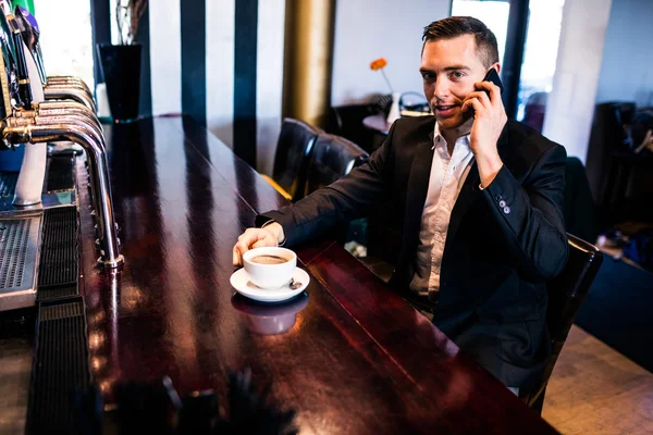 Homme d'affaires au téléphone prenant un café — Photo