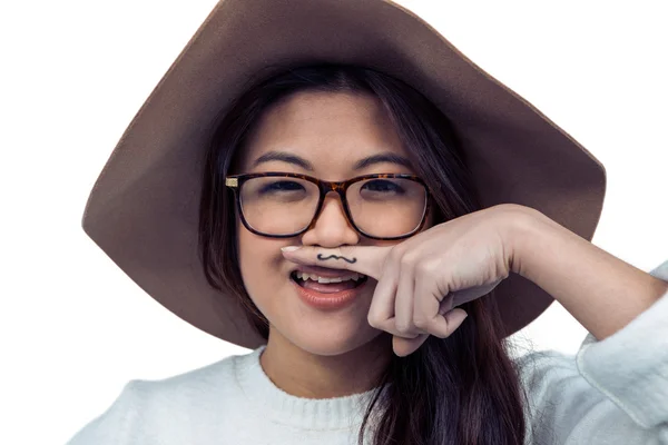 Asian woman with mustache on finger — Stock Photo, Image