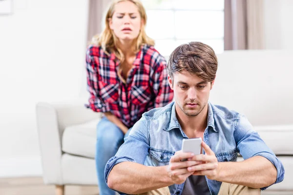 Girlfriend spying on boyfriend texting — Stock Photo, Image