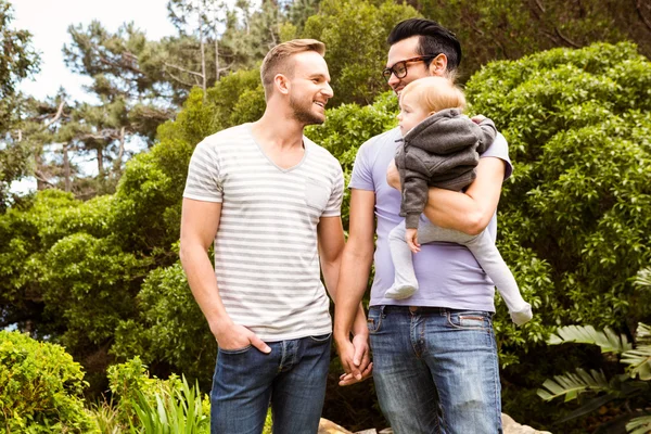 Smiling gay couple with child — Stock Photo, Image